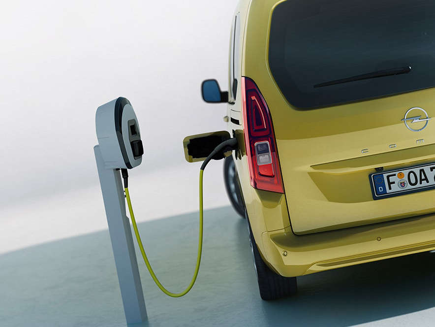Вигляд ззаду на Opel Combo Cargo Electric, що заряджається на зарядній станції для електромобілів